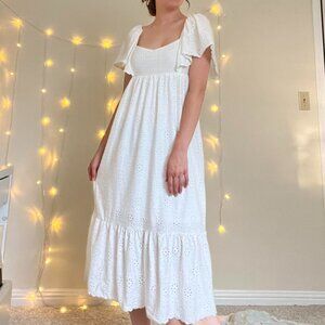 Romantic white dress with scalloped hems and eyelet designs